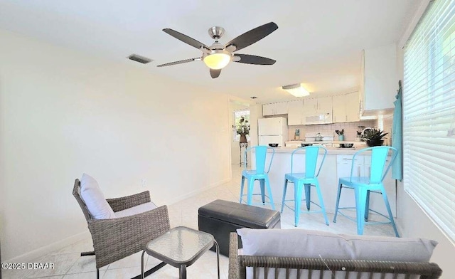 52 Palm Dr, Ormond Beach, FL 32176 - dining space featuring ceiling fan, healthy amount of natural light, and light tile patterned floors