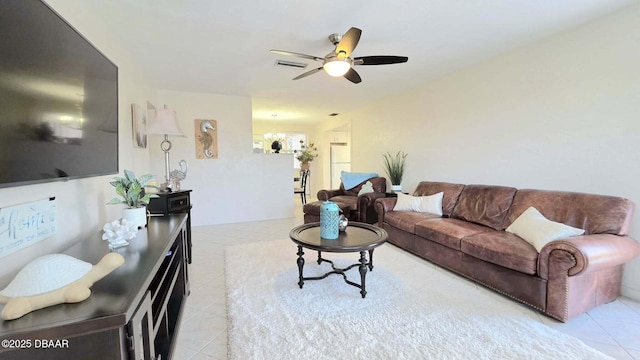 52 Palm Dr, Ormond Beach, FL 32176 - living area with tile patterned floors, ceiling fan, and a chandelier