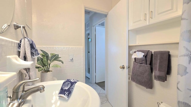 52 Palm Dr, Ormond Beach, FL 32176 - bathroom featuring tile walls, tile patterned floors, and wainscoting
