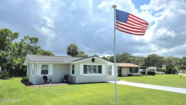 52 Palm Dr, Ormond Beach, FL 32176 - view of front of house with a front yard and stucco siding
