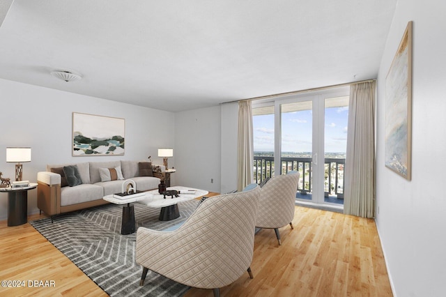 living room with hardwood / wood-style floors and floor to ceiling windows