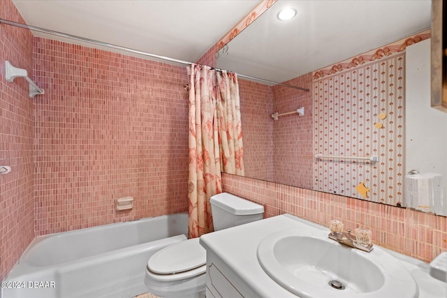 full bathroom featuring shower / bath combination with curtain, backsplash, vanity, toilet, and tile walls