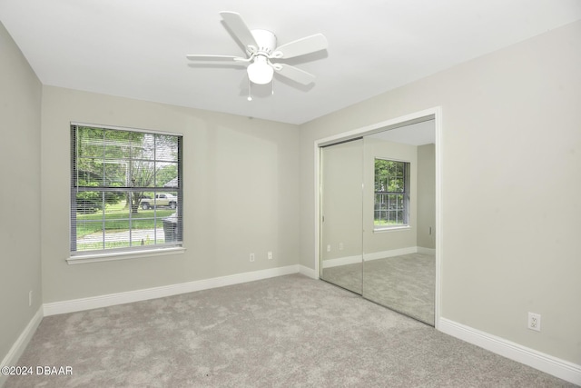 unfurnished bedroom featuring a closet, carpet flooring, and baseboards