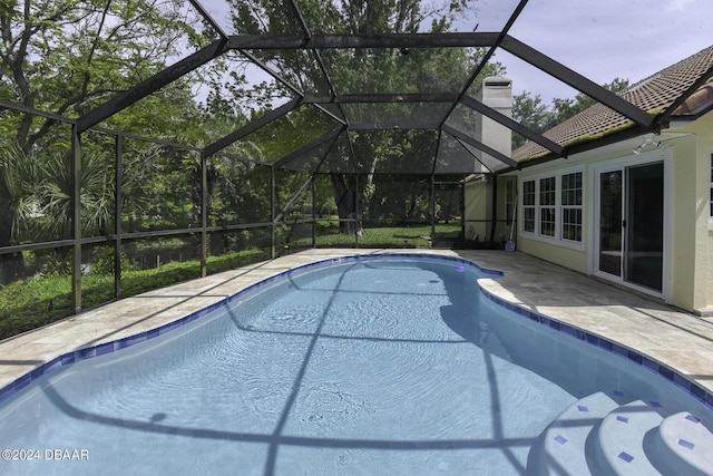 outdoor pool featuring a patio area and a lanai