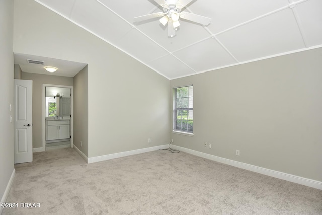 unfurnished room featuring light carpet, baseboards, and vaulted ceiling