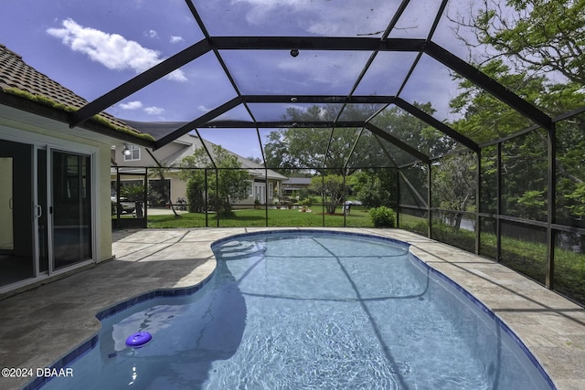 outdoor pool featuring a lanai and a patio area