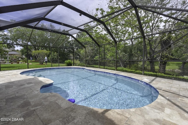 outdoor pool with a lanai and a patio area