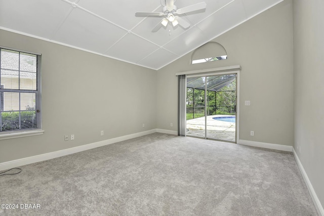 empty room with a ceiling fan, baseboards, vaulted ceiling, and carpet flooring