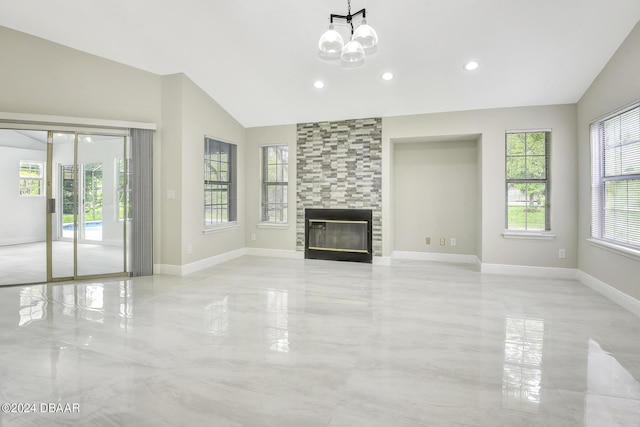 unfurnished living room with marble finish floor, lofted ceiling, a chandelier, a tile fireplace, and baseboards