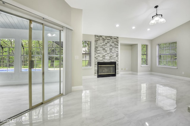 unfurnished living room featuring lofted ceiling, a fireplace, baseboards, and french doors