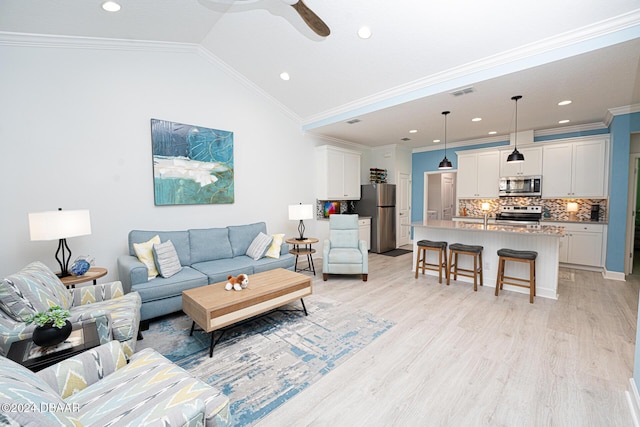 living room with crown molding, ceiling fan, lofted ceiling, and light wood-type flooring