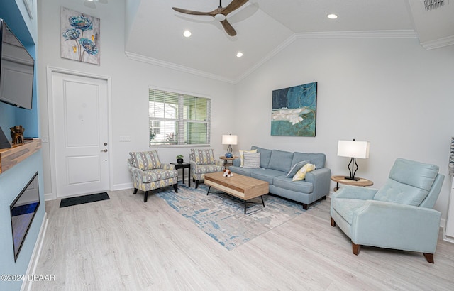 living room with light wood-type flooring, vaulted ceiling, ceiling fan, and ornamental molding