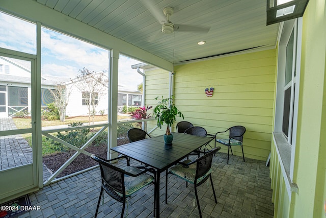 sunroom / solarium featuring ceiling fan