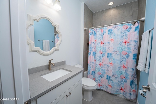 bathroom featuring curtained shower, vanity, and toilet