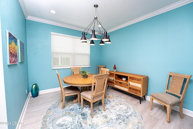 dining area featuring a chandelier, ornamental molding, and hardwood / wood-style flooring