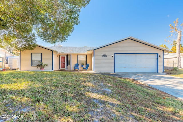 ranch-style house with a garage and a front lawn