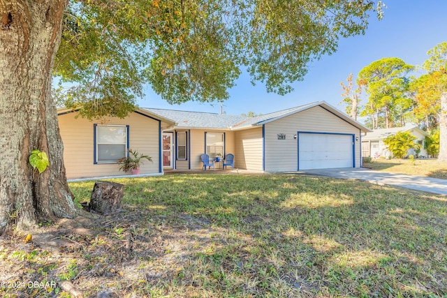 single story home with a front yard and a garage