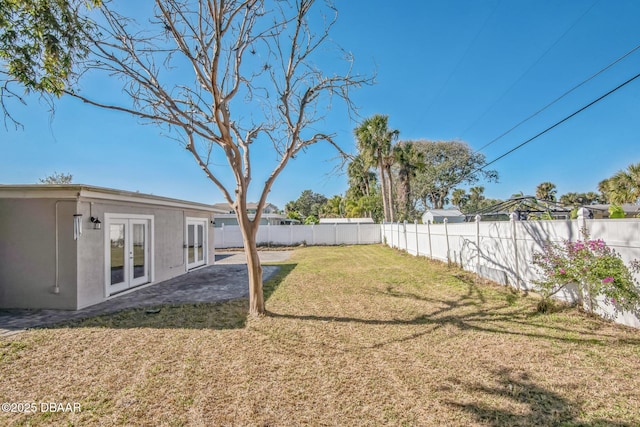 view of yard featuring french doors and a patio area