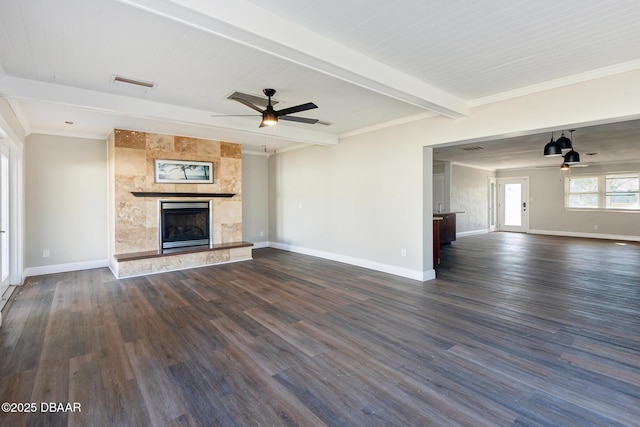 unfurnished living room featuring beam ceiling, a tile fireplace, and dark wood-type flooring