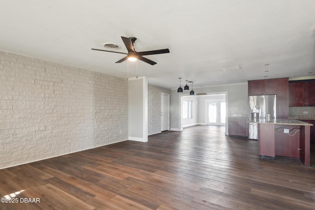 unfurnished living room featuring dark hardwood / wood-style floors and ceiling fan