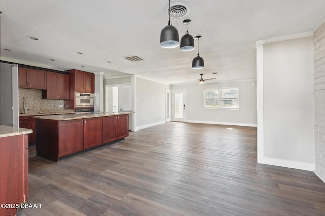 kitchen featuring light stone countertops, ceiling fan, dark hardwood / wood-style flooring, backsplash, and decorative light fixtures