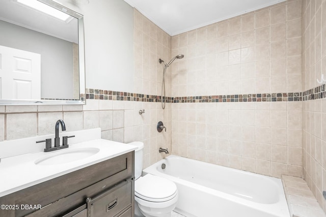 full bathroom featuring tasteful backsplash, vanity, tile walls, toilet, and tiled shower / bath