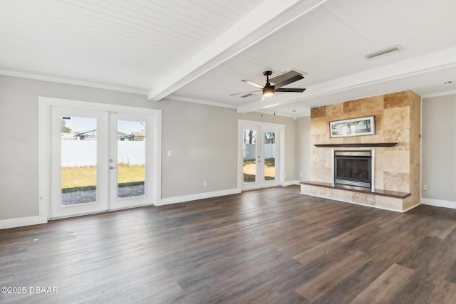 unfurnished living room with a high end fireplace, french doors, wood ceiling, ceiling fan, and beamed ceiling