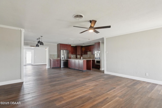 kitchen with dark hardwood / wood-style flooring, ornamental molding, stainless steel appliances, and tasteful backsplash