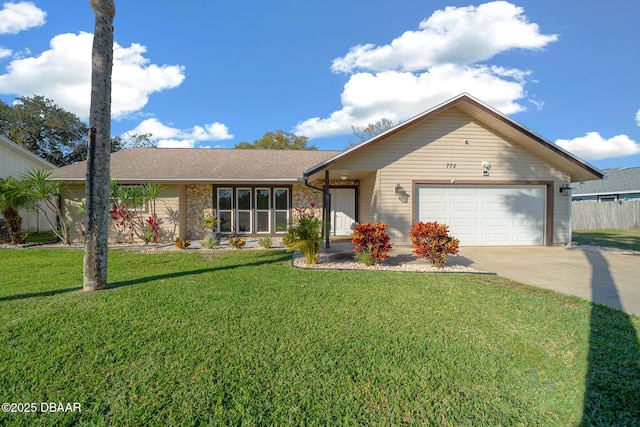 single story home with a garage and a front lawn