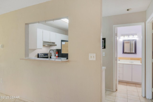 36 Summer Trees Rd, Port Orange, FL 32128 - kitchen featuring light tile patterned floors, under cabinet range hood, light countertops, white cabinetry, and stainless steel electric range oven