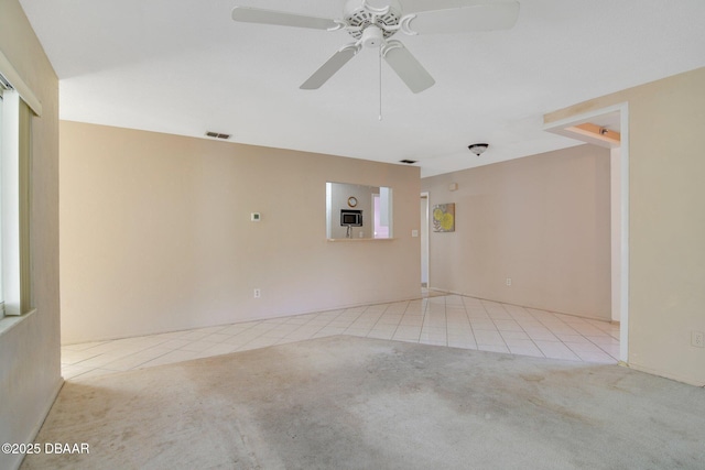 carpeted empty room featuring ceiling fan