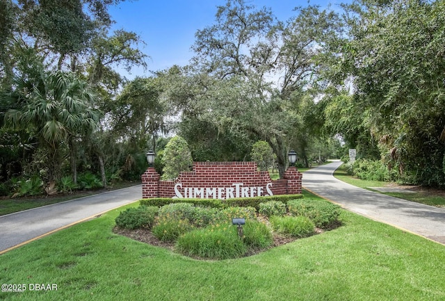 36 Summer Trees Rd, Port Orange, FL 32128 - community / neighborhood sign featuring a lawn and view of wooded area