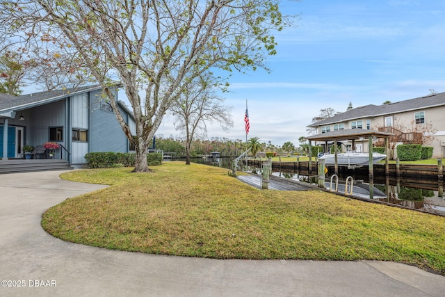 view of yard featuring a dock and a water view