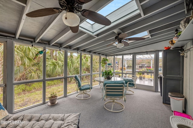 unfurnished sunroom with ceiling fan and lofted ceiling with skylight