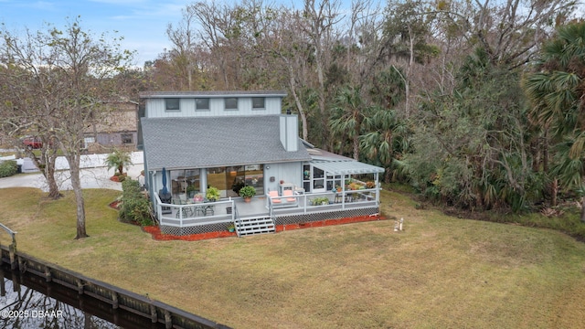 exterior space with a front lawn and a wooden deck