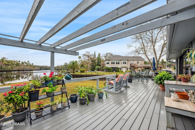 wooden deck with a pergola and a water view