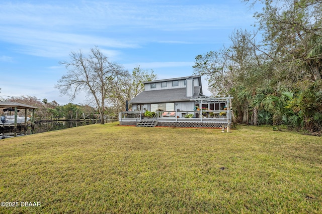 back of house featuring a deck and a lawn