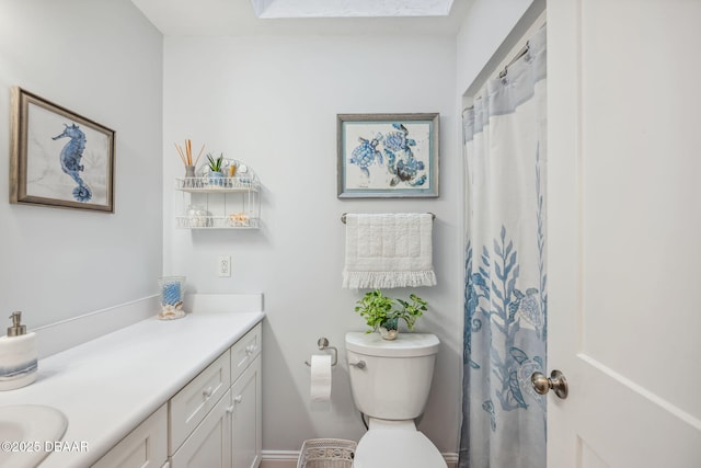 bathroom featuring toilet and vanity