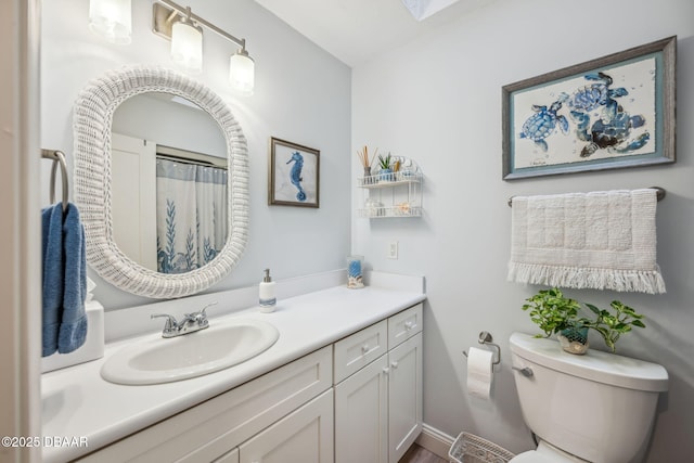 bathroom featuring toilet and vanity