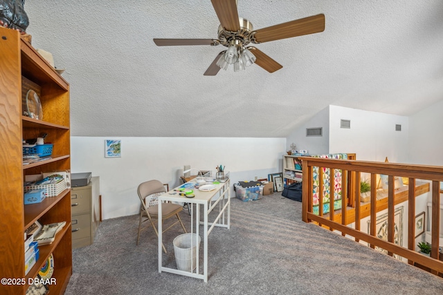 home office with a textured ceiling, ceiling fan, lofted ceiling, and dark carpet