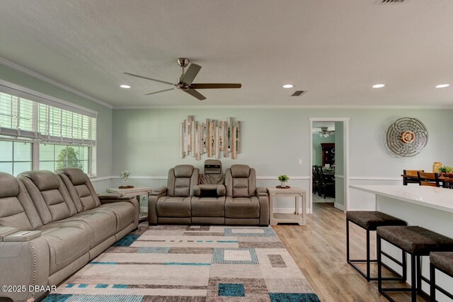 2917 Carriage Dr, South Daytona, FL 32119 - living area featuring a ceiling fan, crown molding, a wainscoted wall, light wood finished floors, and recessed lighting