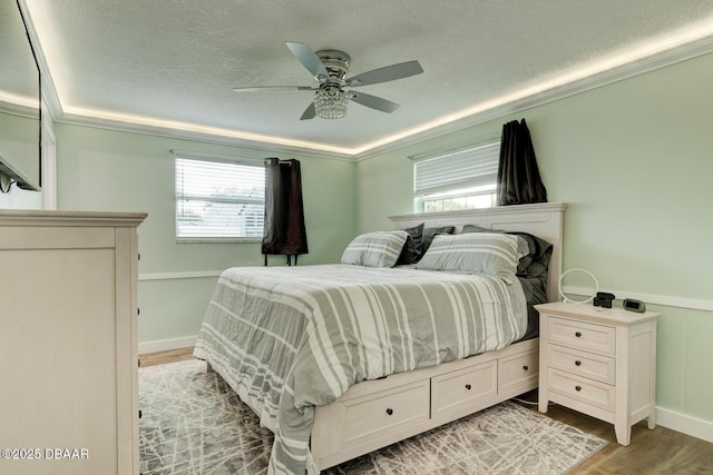2917 Carriage Dr, South Daytona, FL 32119 - bedroom featuring light wood finished floors, a textured ceiling, a ceiling fan, and crown molding