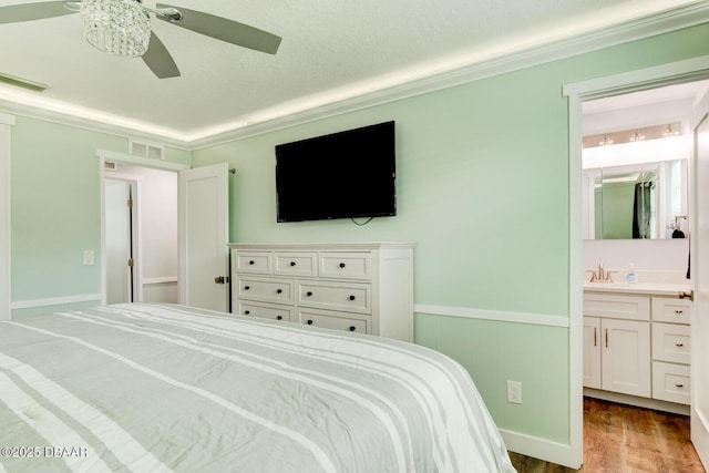2917 Carriage Dr, South Daytona, FL 32119 - bedroom with wood finished floors, connected bathroom, ornamental molding, and a ceiling fan