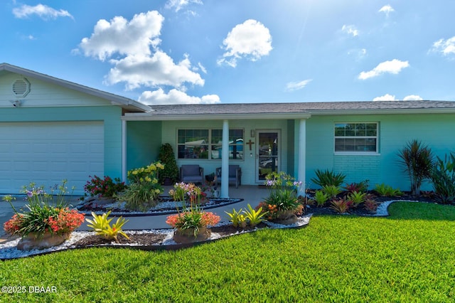 2917 Carriage Dr, South Daytona, FL 32119 - view of front of home featuring a front lawn, an attached garage, and covered porch