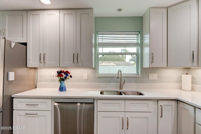 2917 Carriage Dr, South Daytona, FL 32119 - kitchen with stainless steel appliances, light countertops, backsplash, and white cabinetry