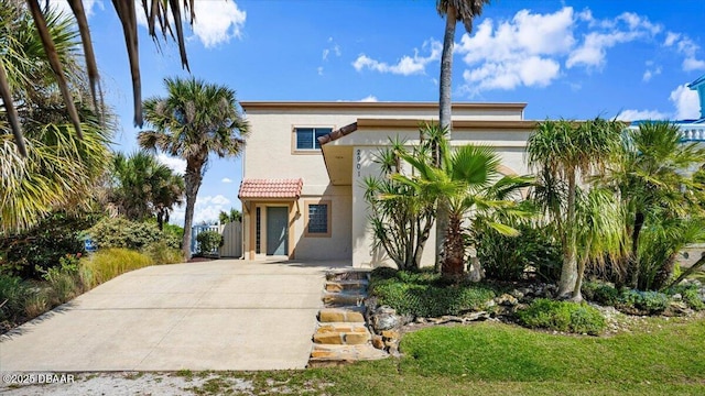 view of front of house with a tile roof and stucco siding