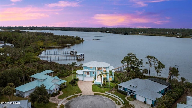 aerial view at dusk with a water view