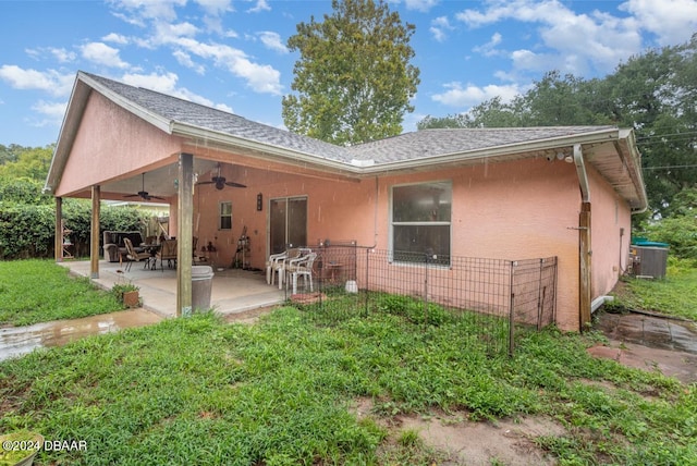 715 Unabelle Ave, Holly Hill, FL 32117 - rear view of property featuring a ceiling fan, stucco siding, a patio, central air condition unit, and a shingled roof