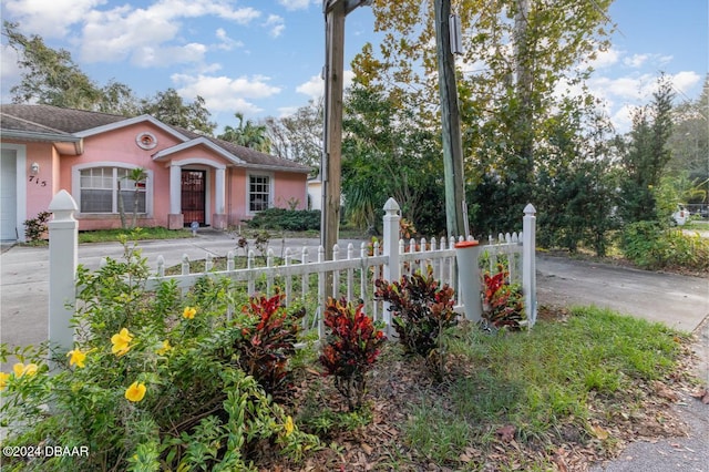 715 Unabelle Ave, Holly Hill, FL 32117 - view of front of property with stucco siding, fence, concrete driveway, and a garage