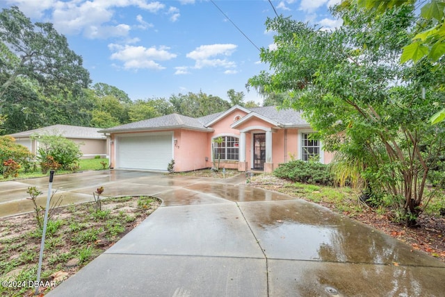 715 Unabelle Ave, Holly Hill, FL 32117 - ranch-style house with stucco siding, an attached garage, and driveway